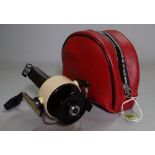 An 'Abu Cardinal 66X' pike fishing reel in a red leather pouch.
