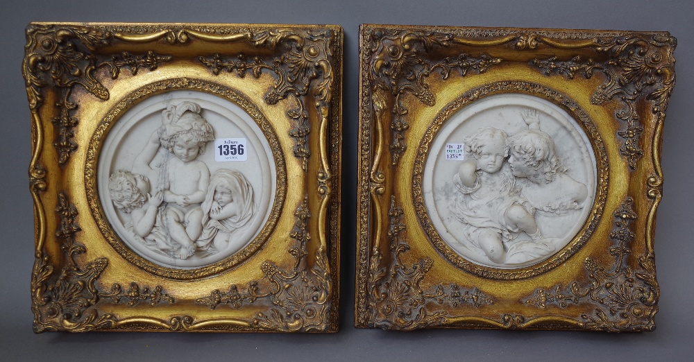 A pair of modern reconstituted circular marble plaques,