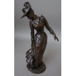 A bronze figure of a Victorian lady, indistinctly signed and dated 1892,