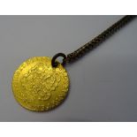 A George III guinea 1785, pierced with a hole, fitted to a Brazil link watch chain, with a swivel,