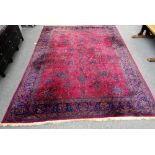 A Mashed carpet, Persian, the burgundy field with an allover floral design,