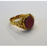 A Victorian 18ct gold and sardonyx set oval signet ring, with foliate decoration to the shoulders,