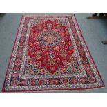 A Khorassan carpet, deep red field with central blue and white medallion and similar spandrels,