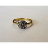 A gold and platinum, diamond set seven stone cluster ring, mounted with circular cut diamonds,