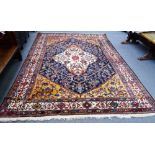 A Bakhtiar carpet, Persian, the dark indigo field with a bold ivory medallion,