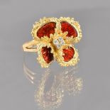 A gold, red enamelled and diamond set ring, designed as a flowerhead,