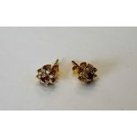 A pair of gold, ruby and diamond nine stone cluster earstuds,