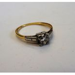 A gold and diamond set single stone ring,