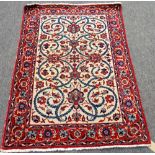 An Isfahan rug, Persian, the ivory field with a central flowerhead,