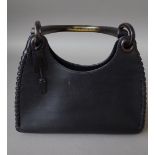 A Gucci black leather handbag, with ebonised wooden handle, 29cm wide.