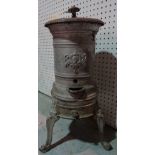 An early 20th century French cast iron stove on three cabriole supports, 25cm wide x 65cm high.