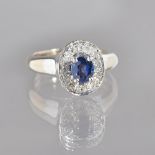 A white gold, sapphire and diamond oval cluster ring,