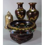 A 20th century cloisonné black ground bowl decorated with a dragon and a matching pair of baluster