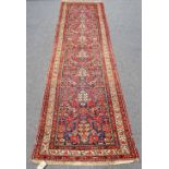 A Hamadan runner with all-over stylised floral design on a midnight blue ground with ivory main