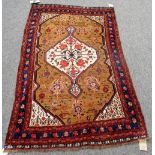 A Ghasghai rug, the brown field with an ivory diamond of flowers ivory spandrels,