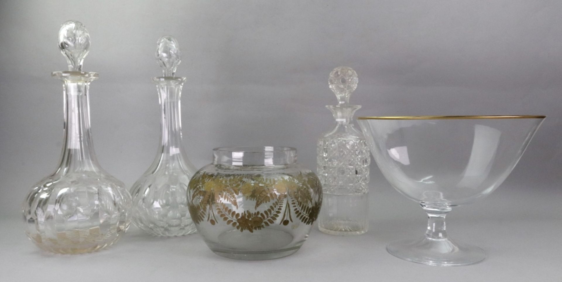 A pair of Edwardian facet cut glass decanters, of baluster shape, 32cm high,
