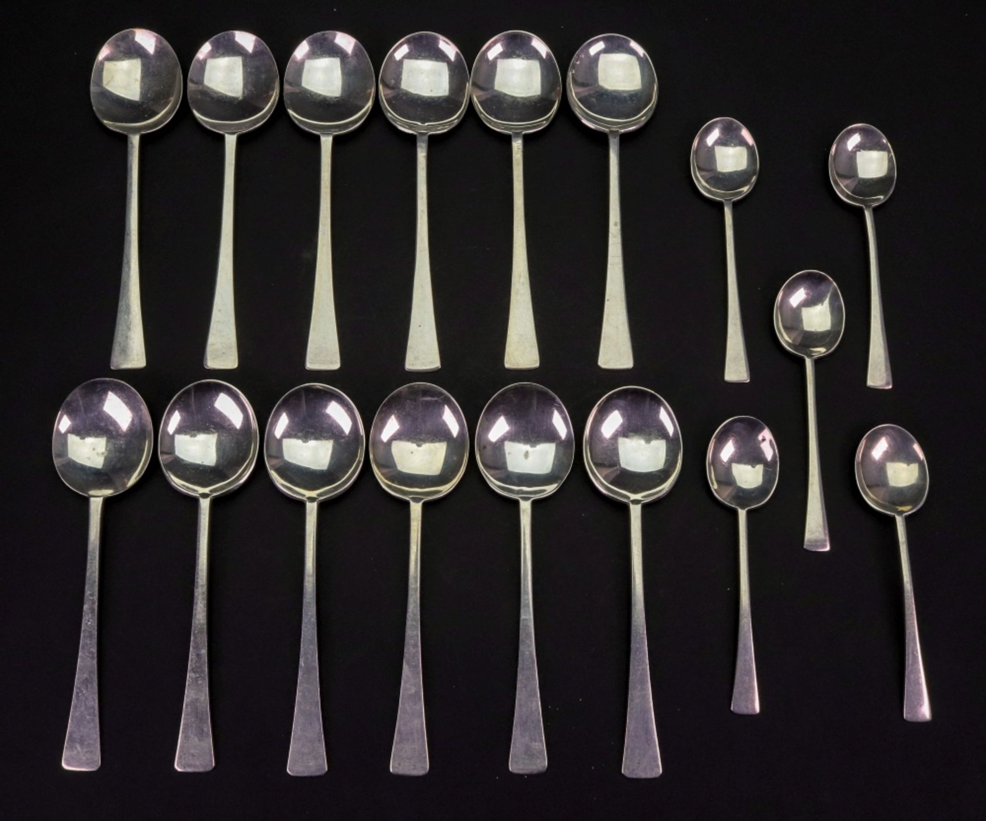 Two sets of six Art Deco silver fruit spoons, Birmingham 1926 & 1927 and Sheffield 1923 & 1924,