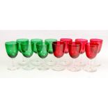 A set of six cranberry coloured drinking glasses and a set of six in green (12).