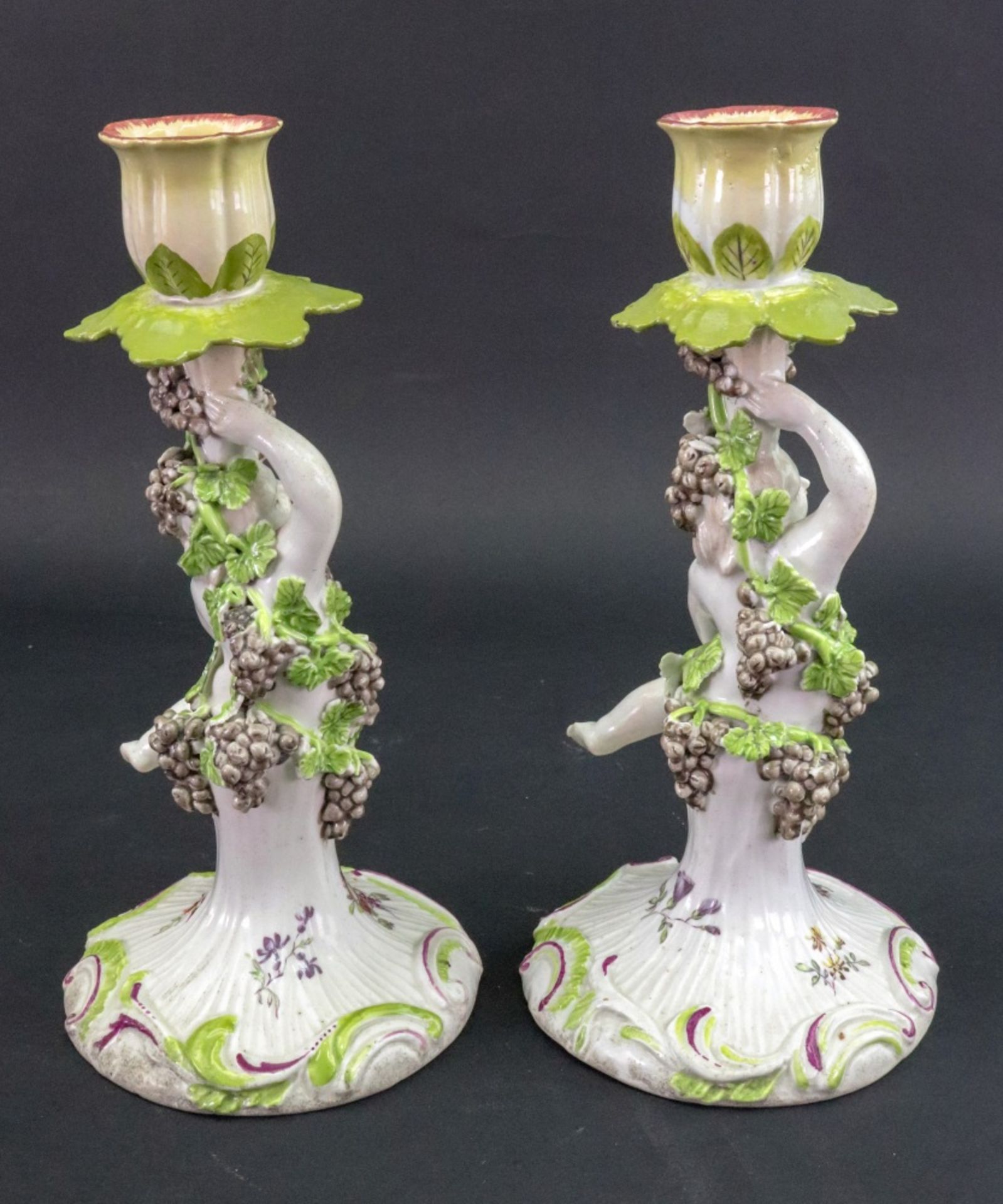 A pair of Derby porcelain candlesticks, circa 1760, each modelled as a putto holding a cup, - Image 2 of 2
