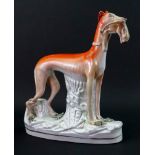 A large Staffordshire pottery figure of a greyhound with a hare in its mouth, late 19th century,