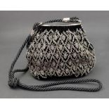 Gucci; a velvet and beaded evening bag with black rope shoulder strap and side locking clasp,