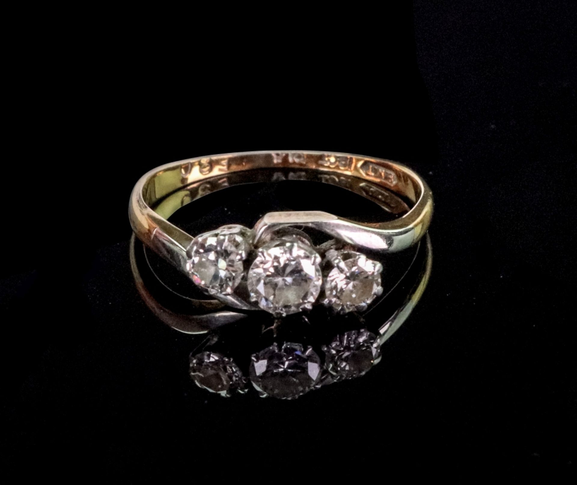 A gold and diamond three stone twist ring, the central round diamond weighs approximately 0. - Image 2 of 2