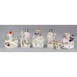 A pair of Victorian Staffordshire pottery figures of children with pet birds and rabbits, 16cm high,