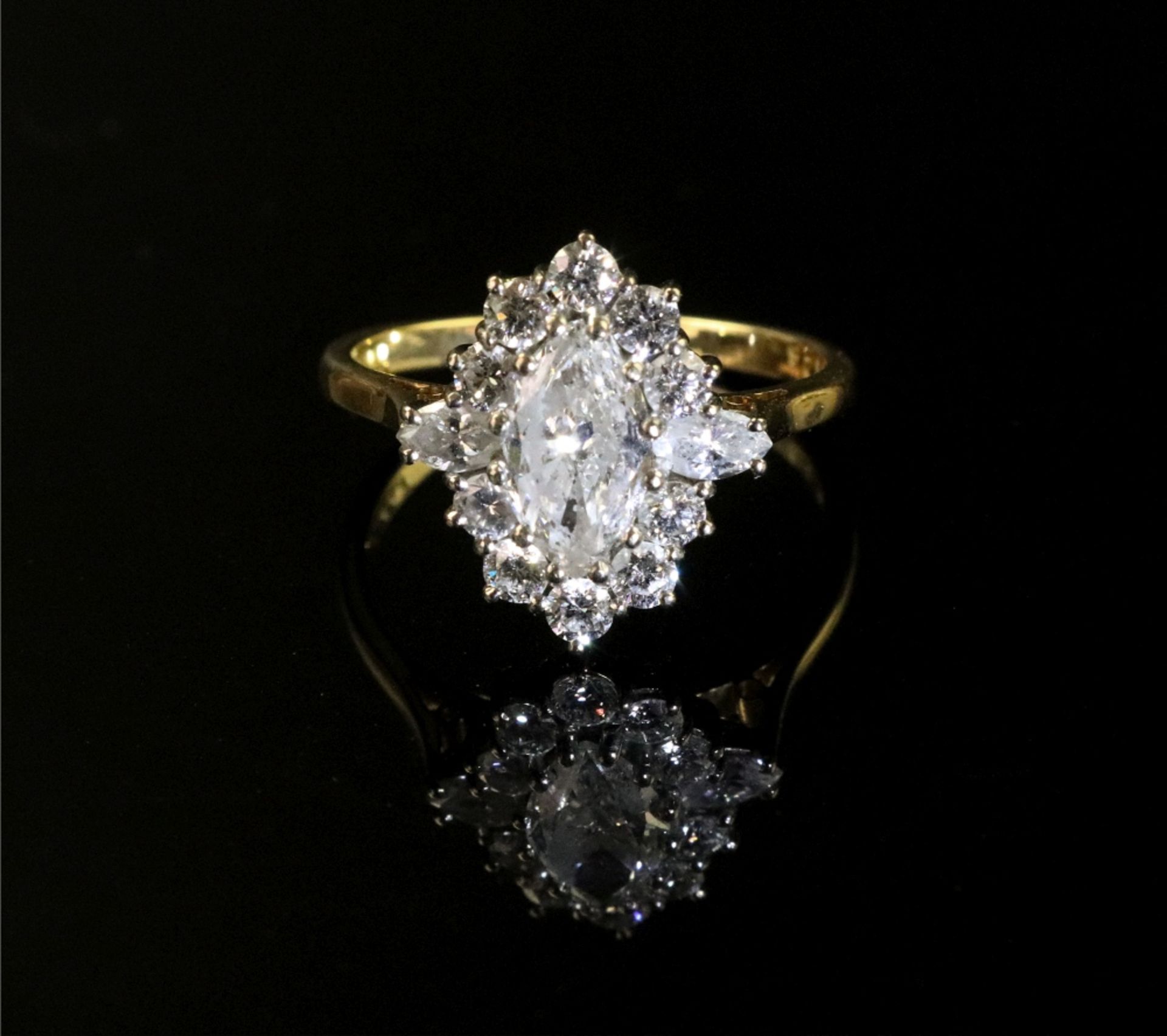 An 18ct gold and marquise diamond cluster ring, the central marquise diamond,