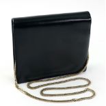 Launer, London; a black leather shoulder bag of square form, with gilt metal chain,