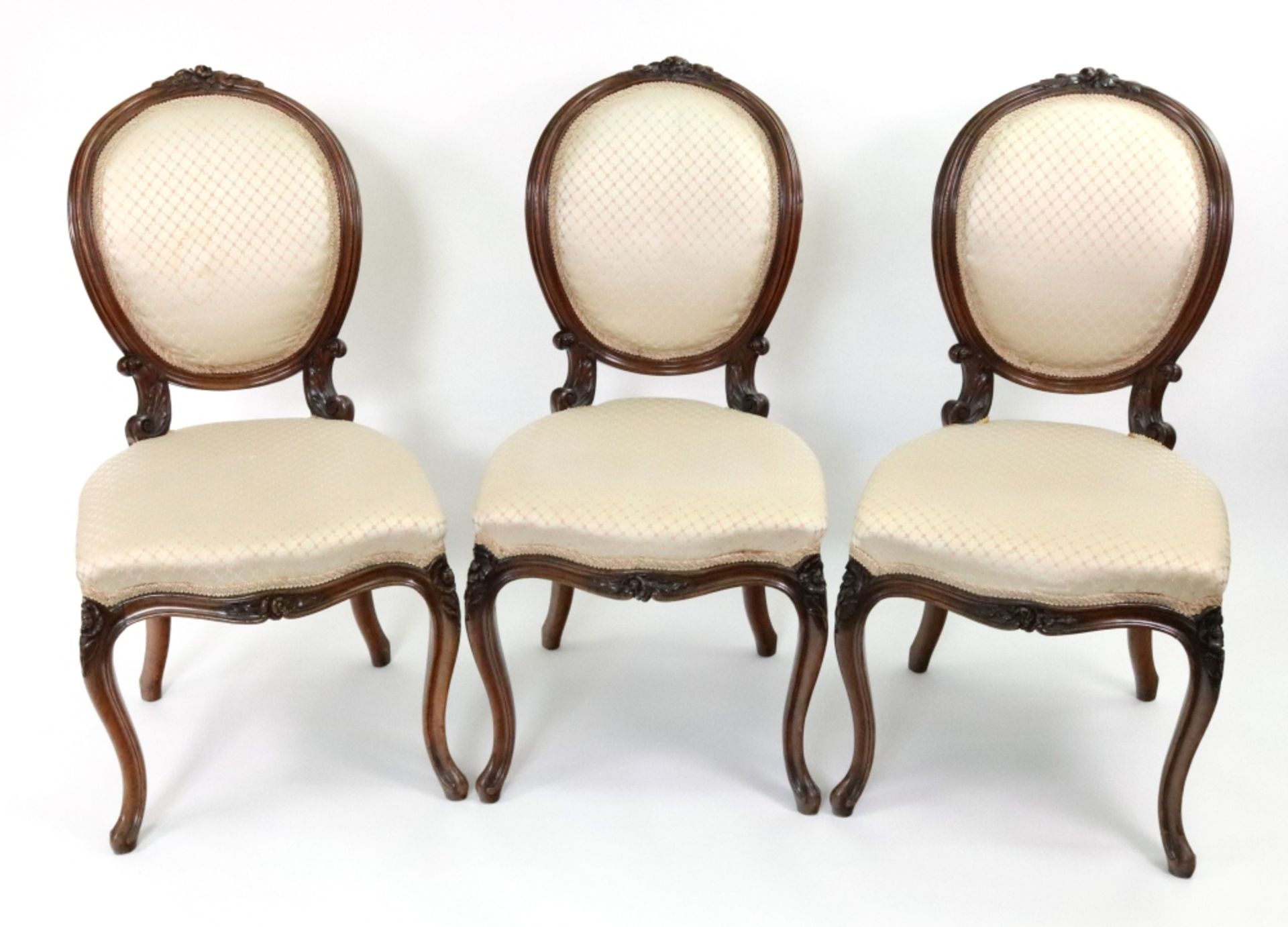 A set of three Louis XVI style foliate carved walnut frame salon chairs, second half 19th century,