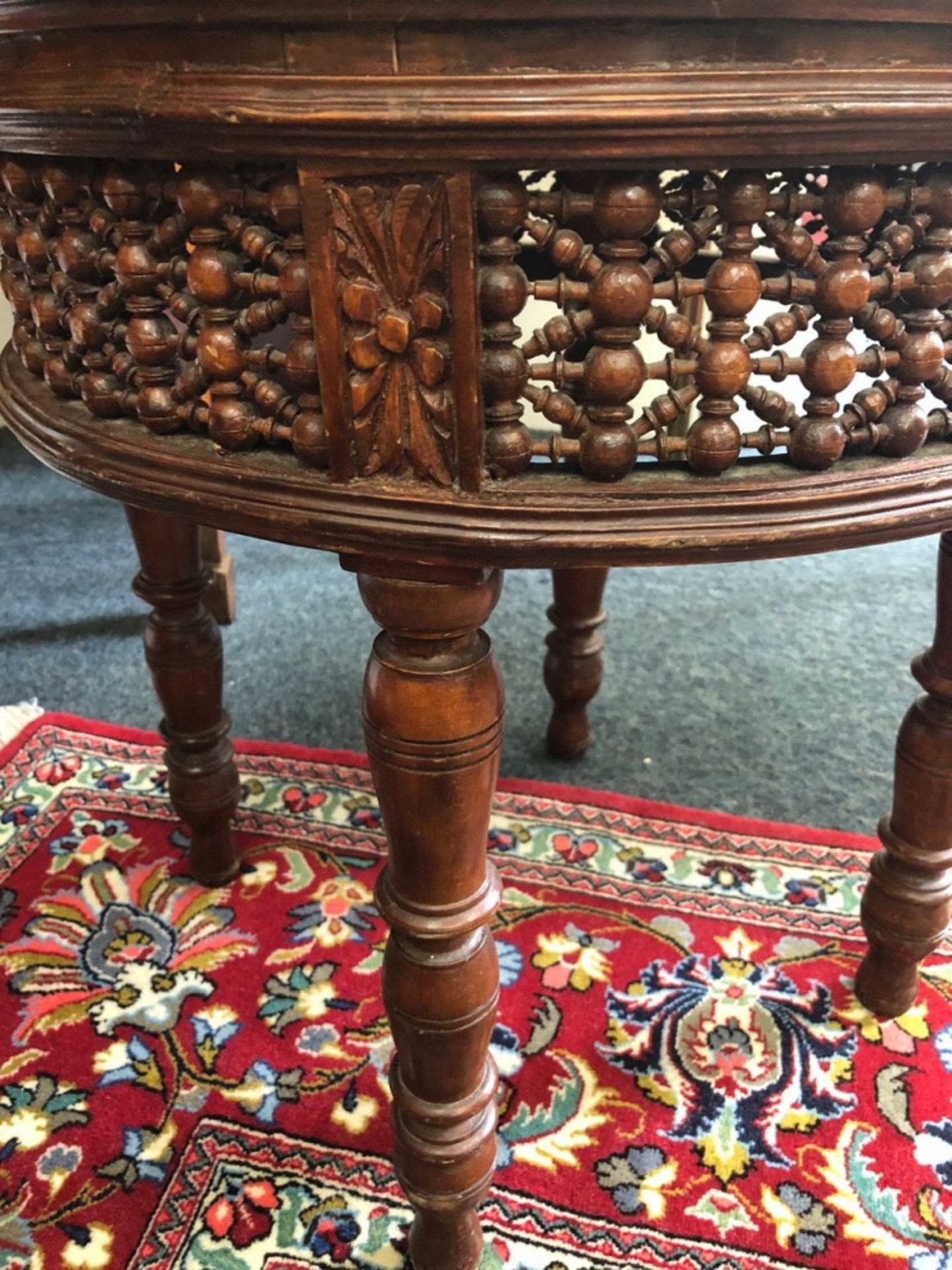 An Indo Persian mahogany circular stand, with a spindle filled frieze, on four ring turned legs, - Image 4 of 4