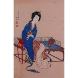 A Japanese woodblock print of a seated lady, signed, 29 x 19cm.
