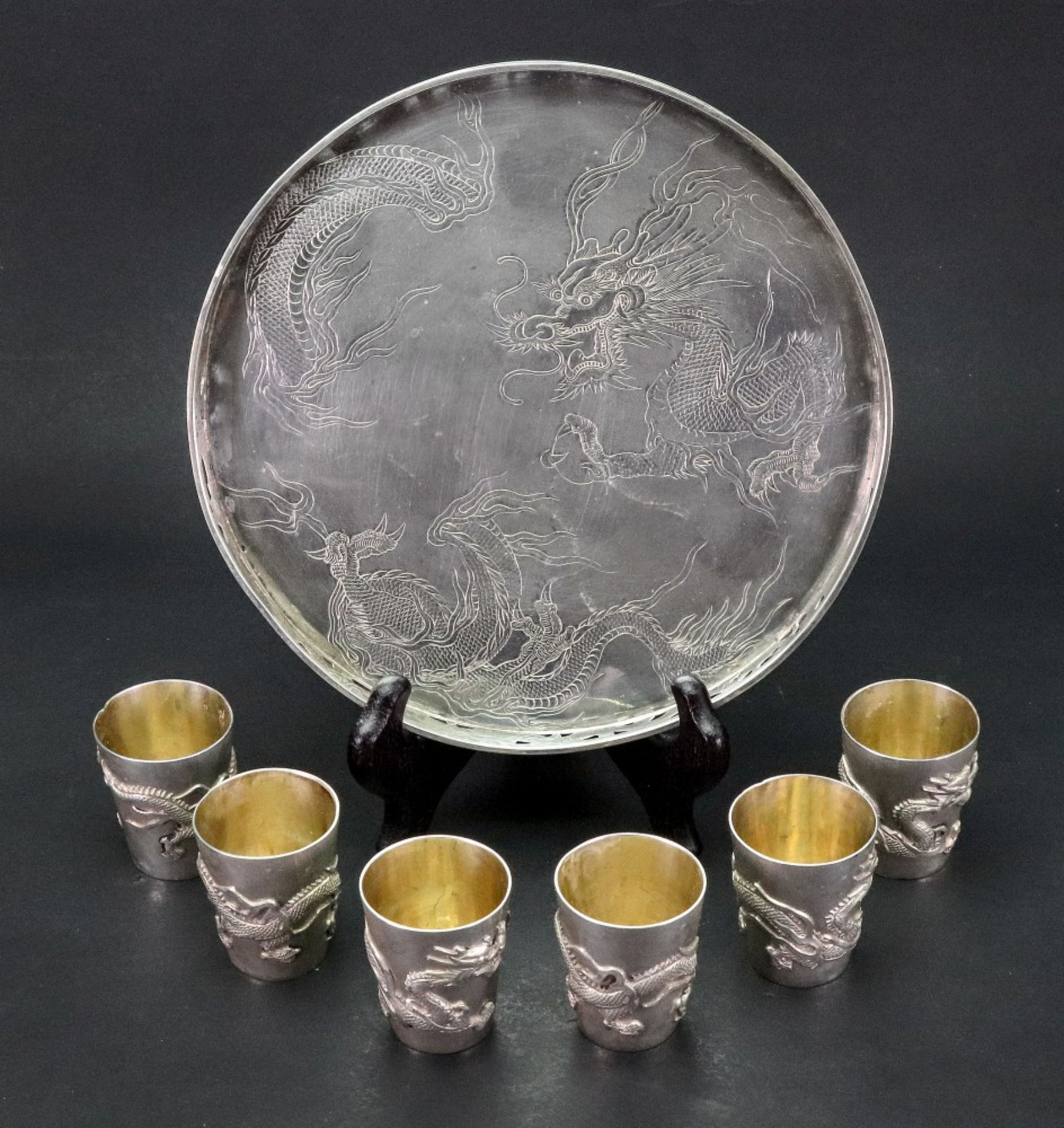 A Chinese silver circular tray and set of six silver cups, Wang Hing & Co, circa 1900,