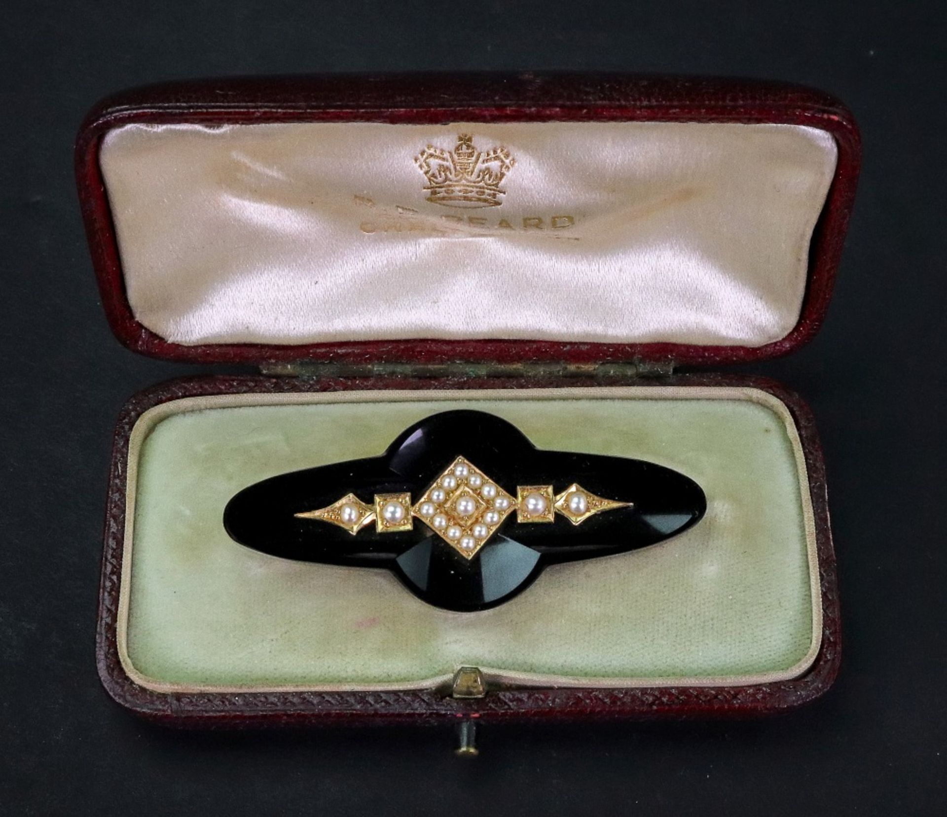 A Victorian gold brooch, the central motif set with gold and seed pearl design,