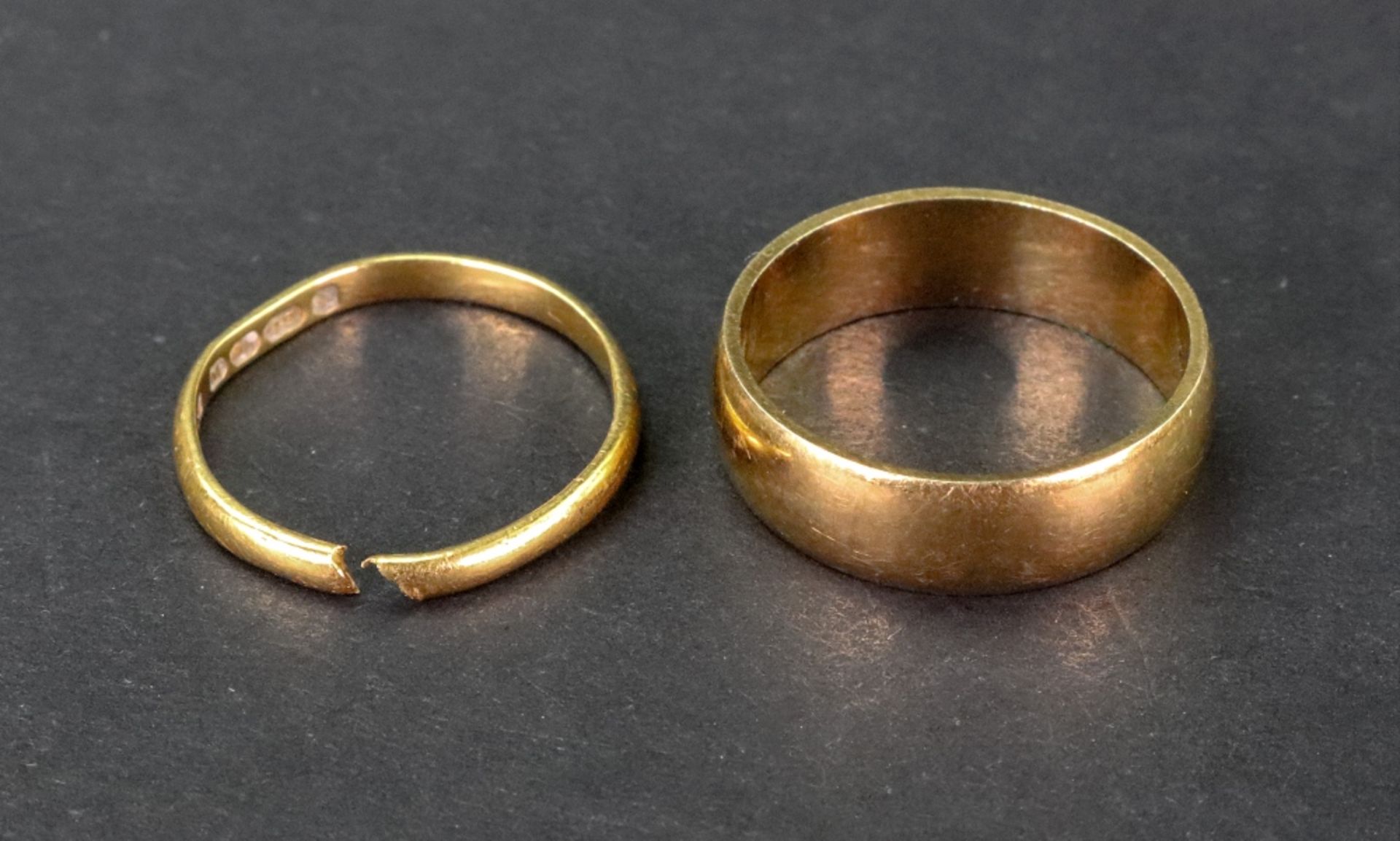 An 18ct gold wedding band and another 22ct gold wedding band, 6.90g gross.