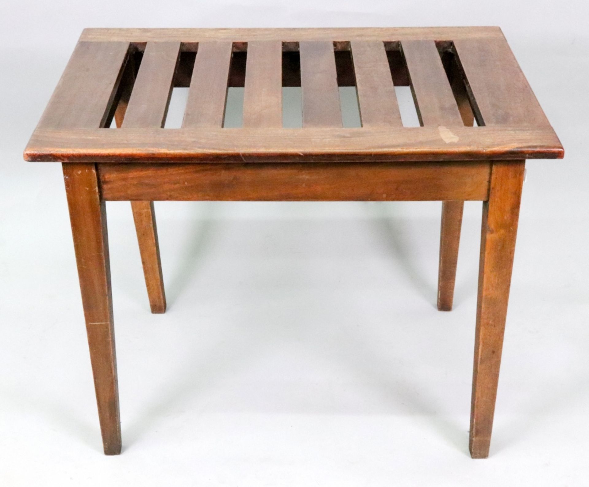 An Edwardian mahogany luggage rack, the slatted rectangular top on square tapered legs,