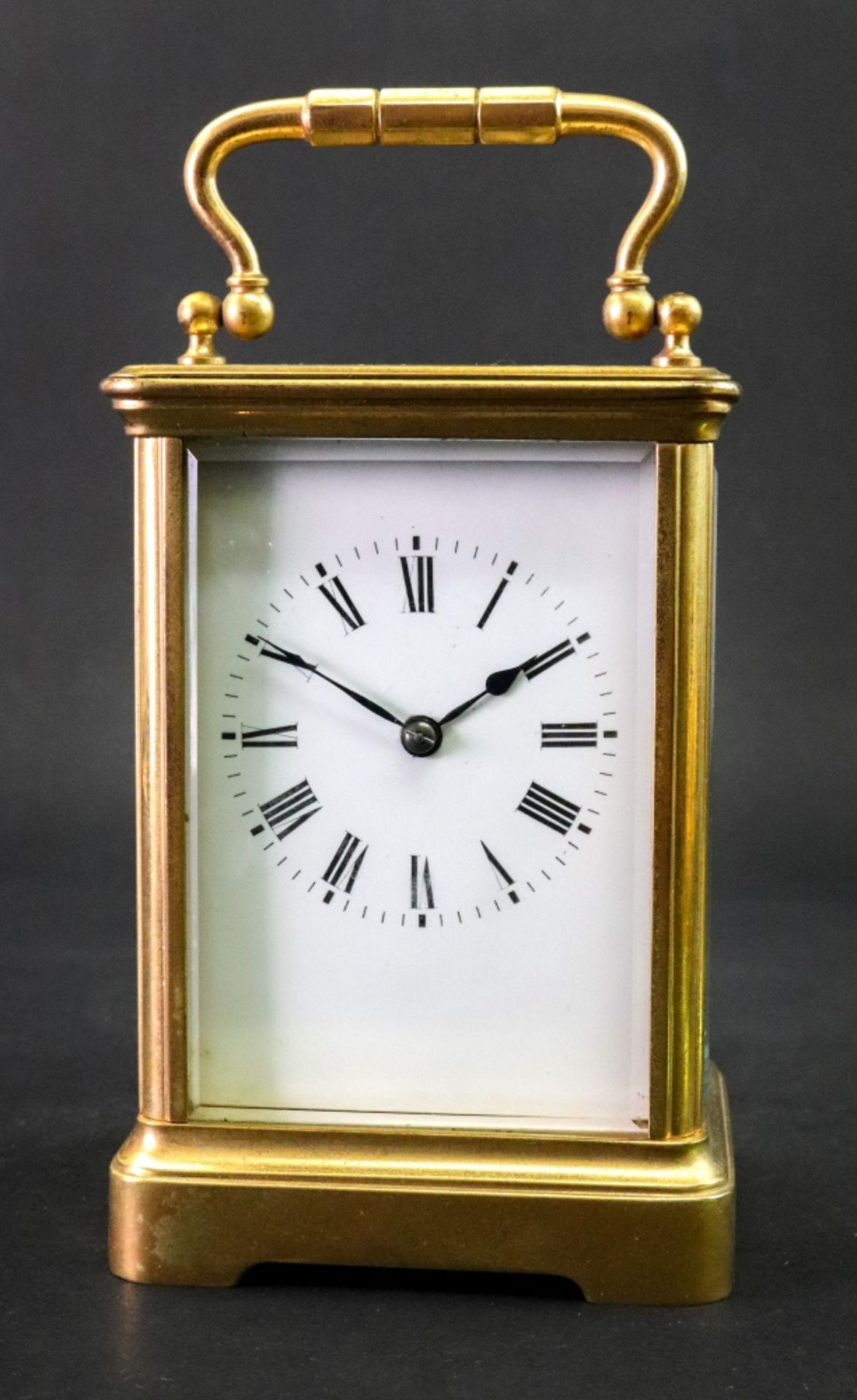 A large brass cased carriage clock, early 20th century, the white enamel dial with Roman numerals,