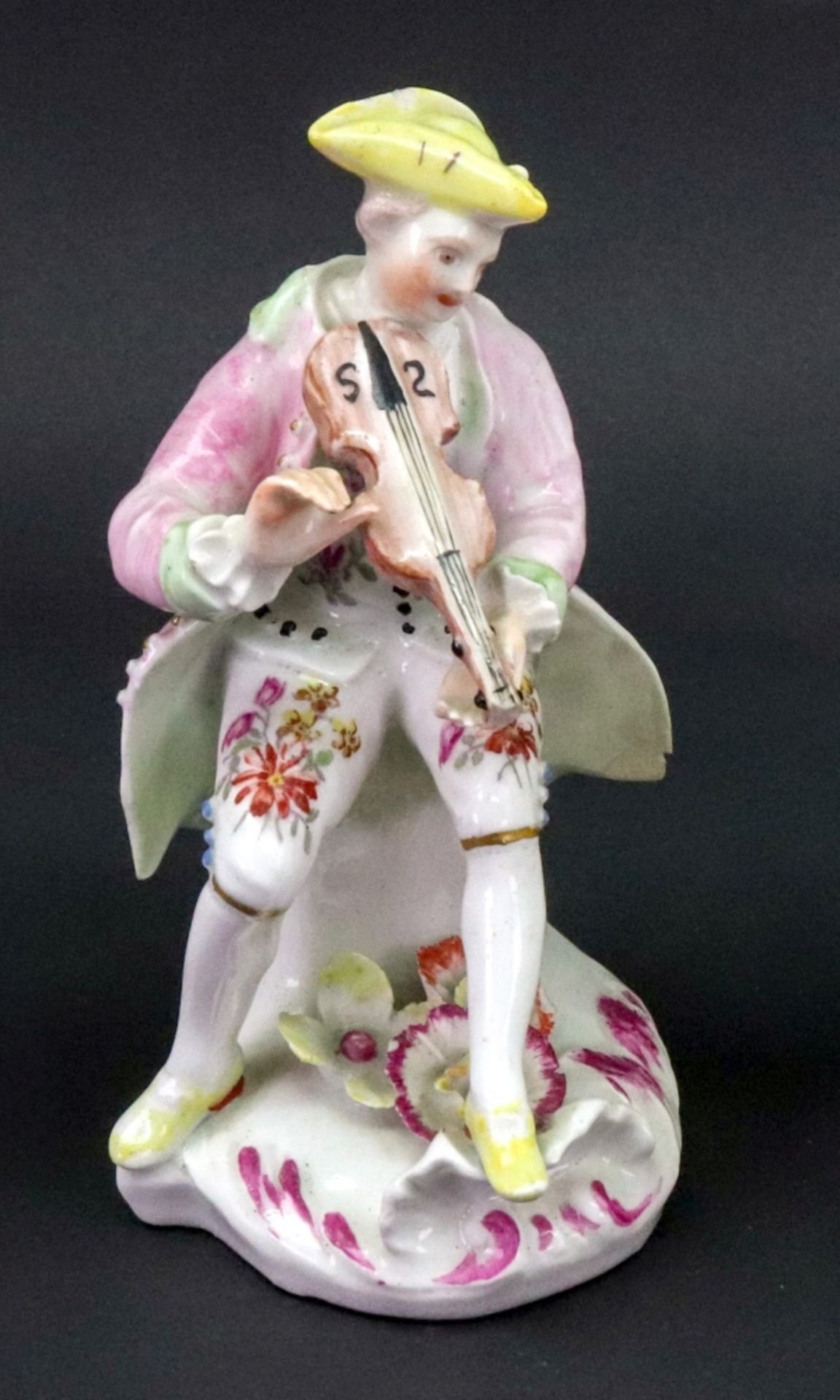 A Derby figure of a musician, circa 1758-60, modelled as a young man seated playing the violin,