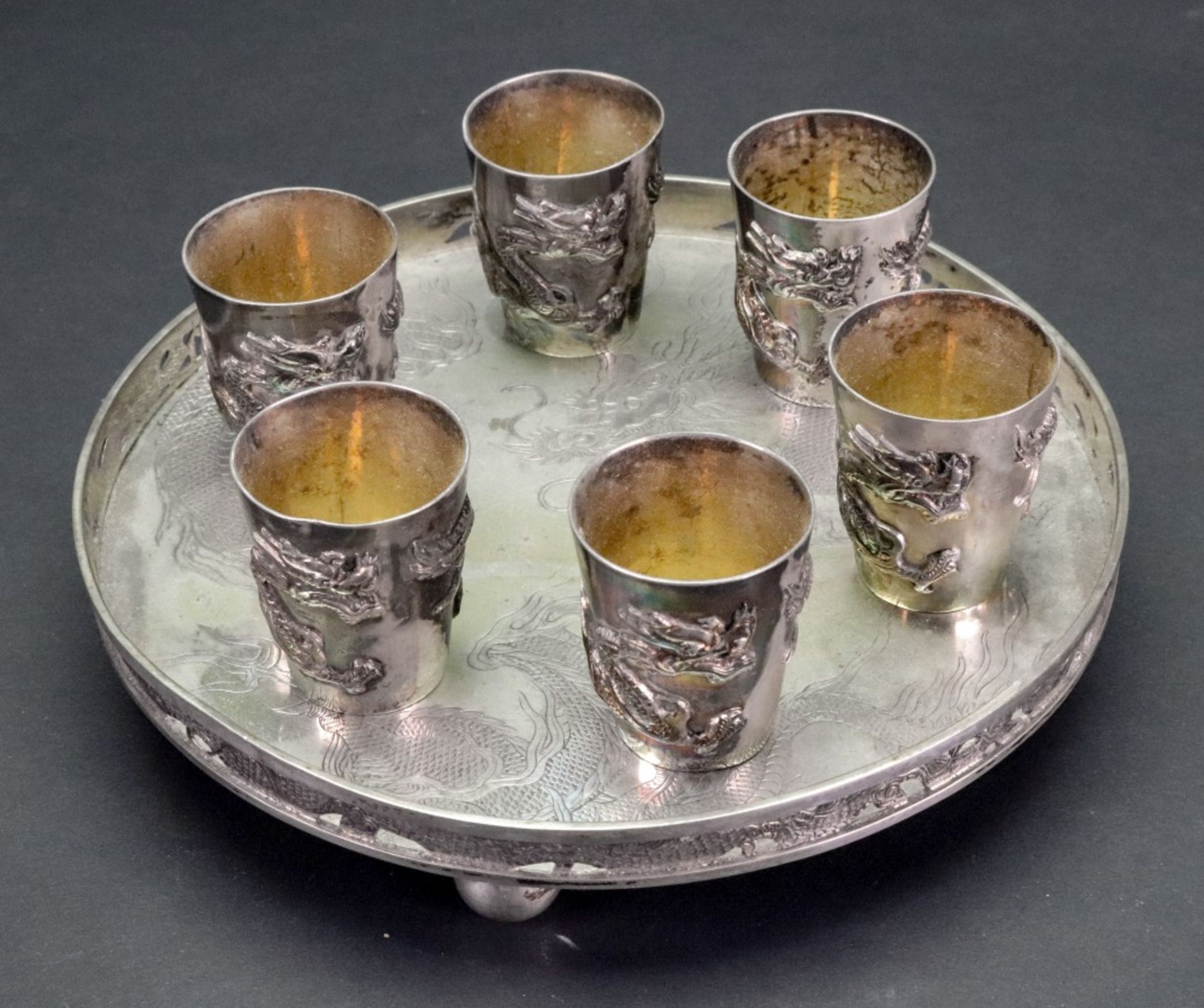 A Chinese silver circular tray and set of six silver cups, Wang Hing & Co, circa 1900, - Image 3 of 6