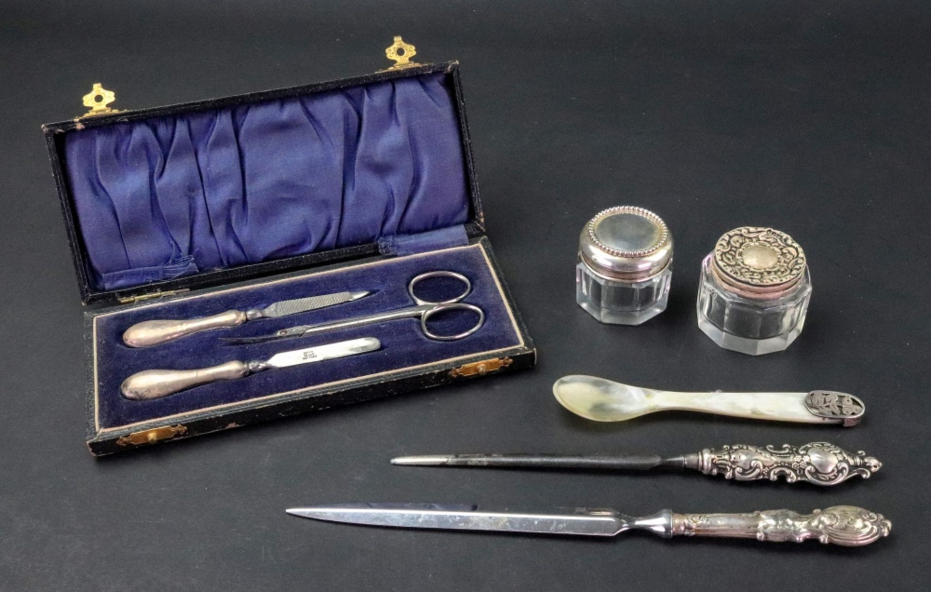 Two ornate silver handled paper knives, one, Birmingham 1904,