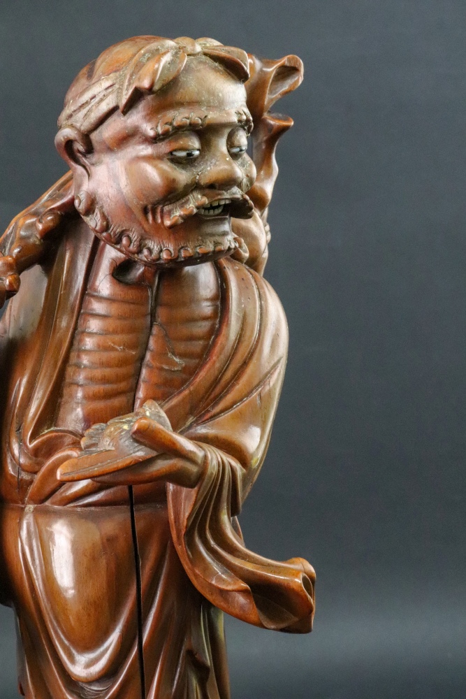 A Chinese carved wood figure of a man carrying a branch over his shoulder, 20th century, 38cm high. - Image 2 of 2