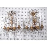 A pair of Victorian gilt brass four branch wall lights each backplate of Gothic form,