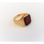 A 9ct gold and cut cornered rectangular cornelian set signet ring, London 1978,