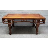 A late 19th/ early 20th century Chinese hardwood low table with pierced frieze on block supports,