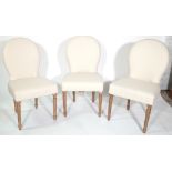 A set of three 20th century hardwood framed spoon back dining chairs on floral tapering supports.
