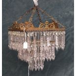 A Victorian style gilt metal three tier bag chandelier of tapering square section hung with glass