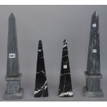 A pair of grey marble obelisks,