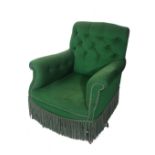 An early 20th century mahogany framed Heals style low armchair on tapering supports with green