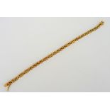 A gold bracelet, in a bar and oval link design, on a snap clasp, detailed 750, length 18.