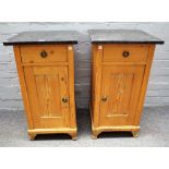 A pair of marble topped bedside tables with pine single drawer over cupboard base,